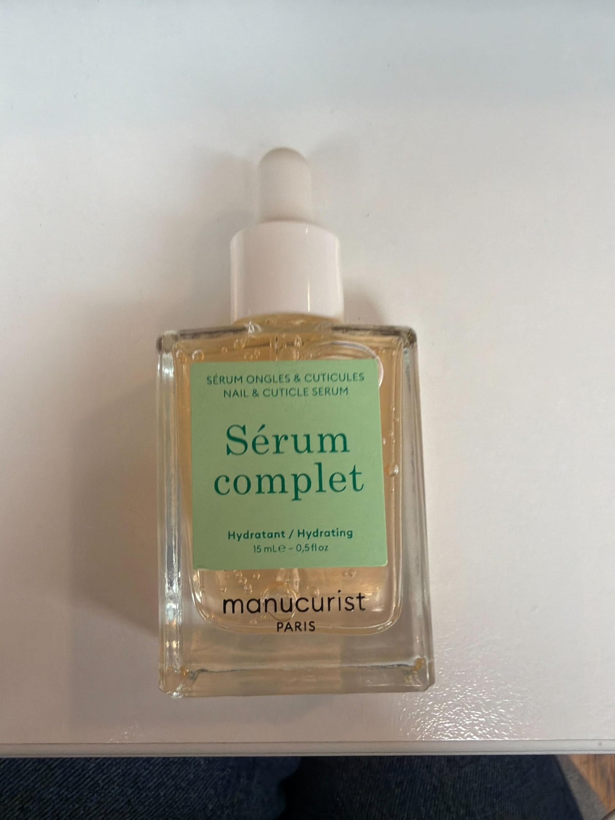 Manucurist bottles next to ruler showing compact travel-friendly size