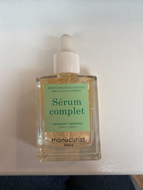 Manucurist bottles next to ruler showing compact travel-friendly size