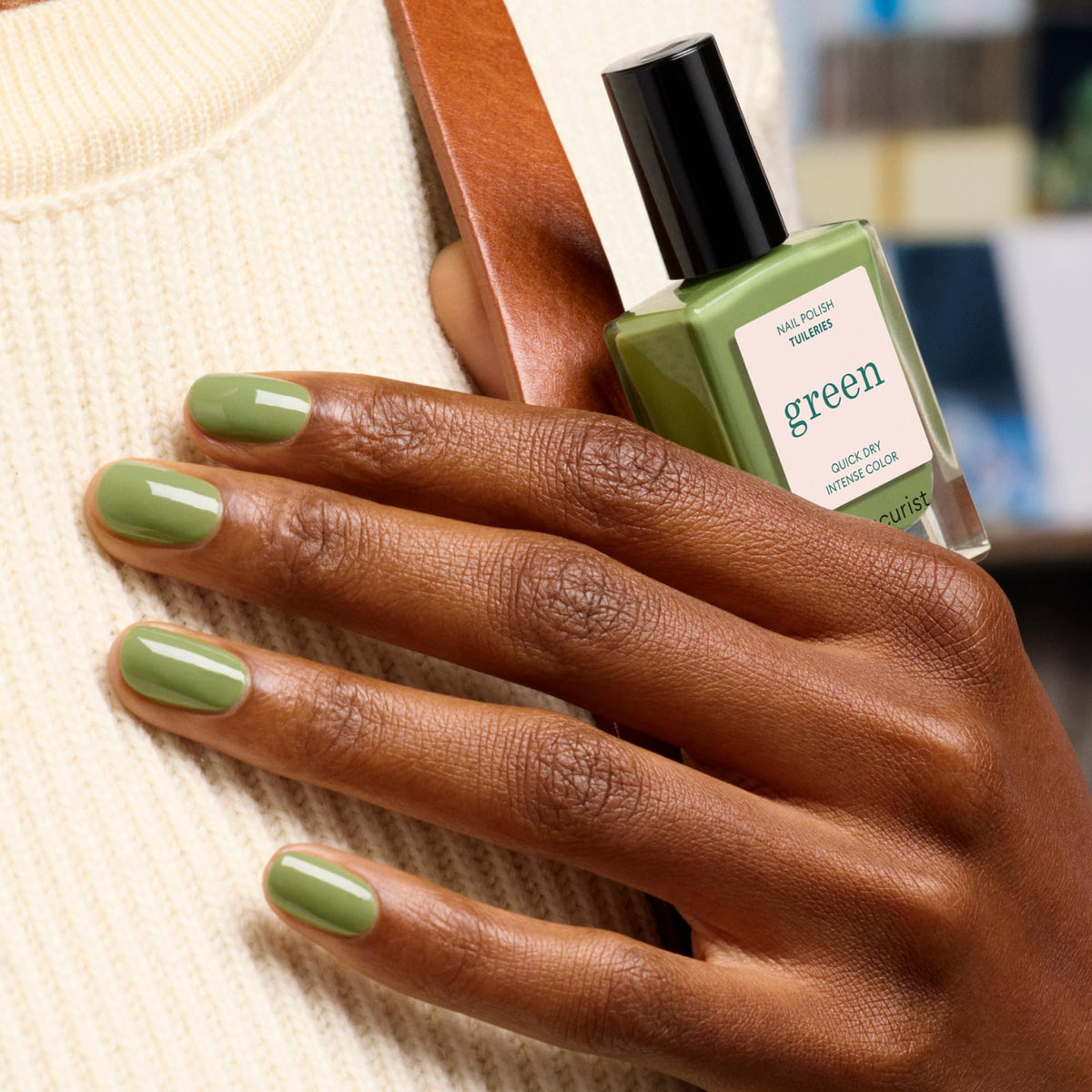 Manucurist swatch on fingertips revealing true olive color and opacity