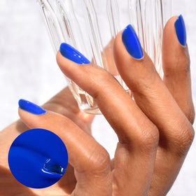 Manucurist brush spreading Ultramarine blue for even application benefit