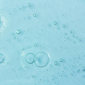 Mario Badescu body wash in use on wet skin with sponge demonstrating calming cleanse
