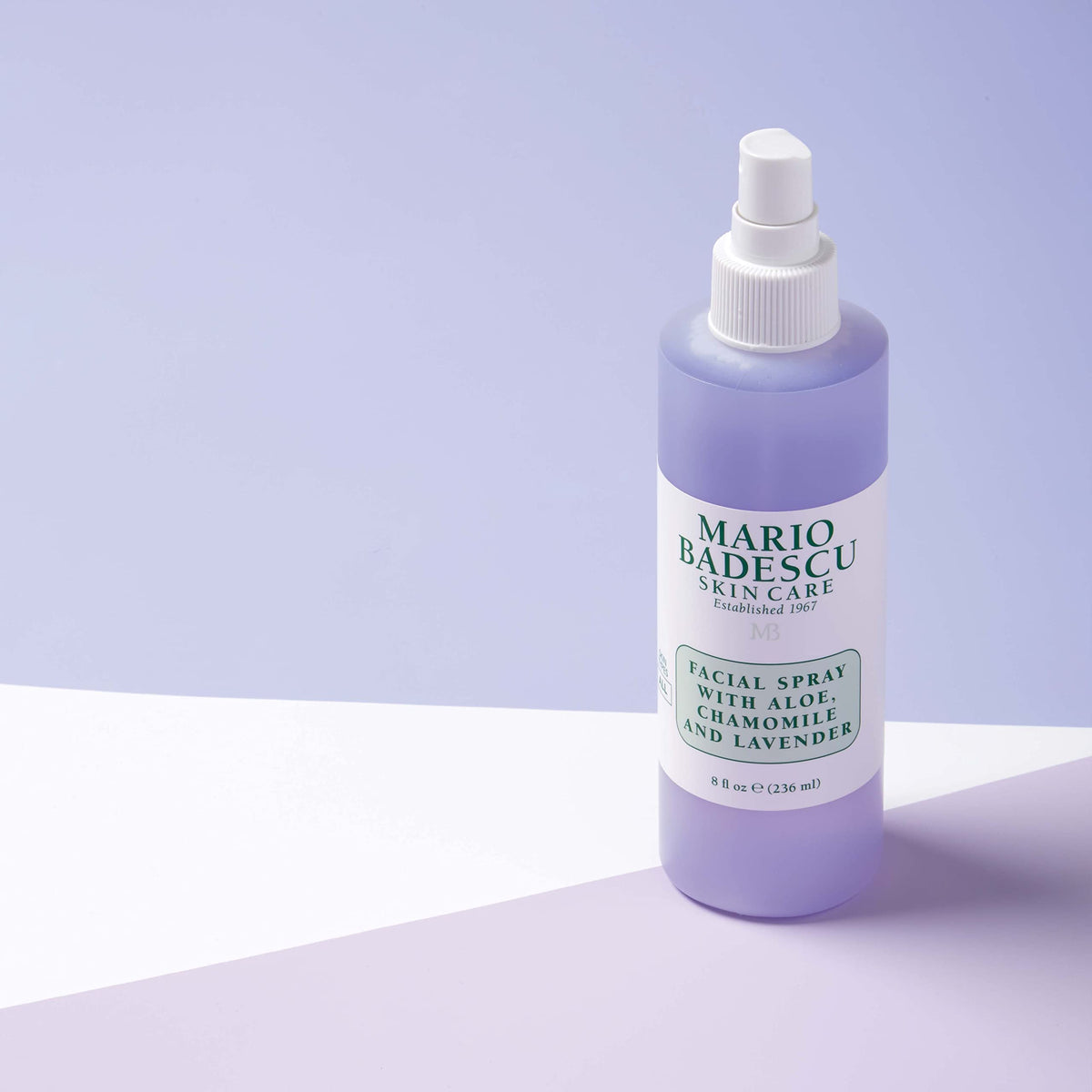 Mario Badescu bottle beside a hand to show 8 fl oz size and portability benefit