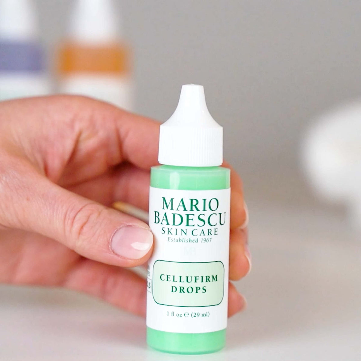 Mario Badescu bottle next to coin showing 1 fl oz size for travel-friendly use