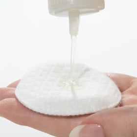 Mario Badescu applied with cotton pad on cheek to remove oil and impurities