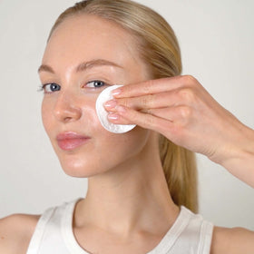 Mario Badescu toner texture pouring from bottle onto hand, benefits visible lightweight consistency