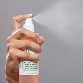Mario Badescu bottle in hand to show 4 fl oz scale, convenient travel-friendly benefit