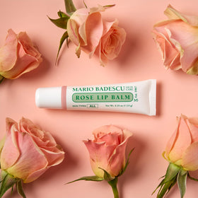 Mario Badescu lip balm tubes next to ruler scale to show compact travel-friendly size