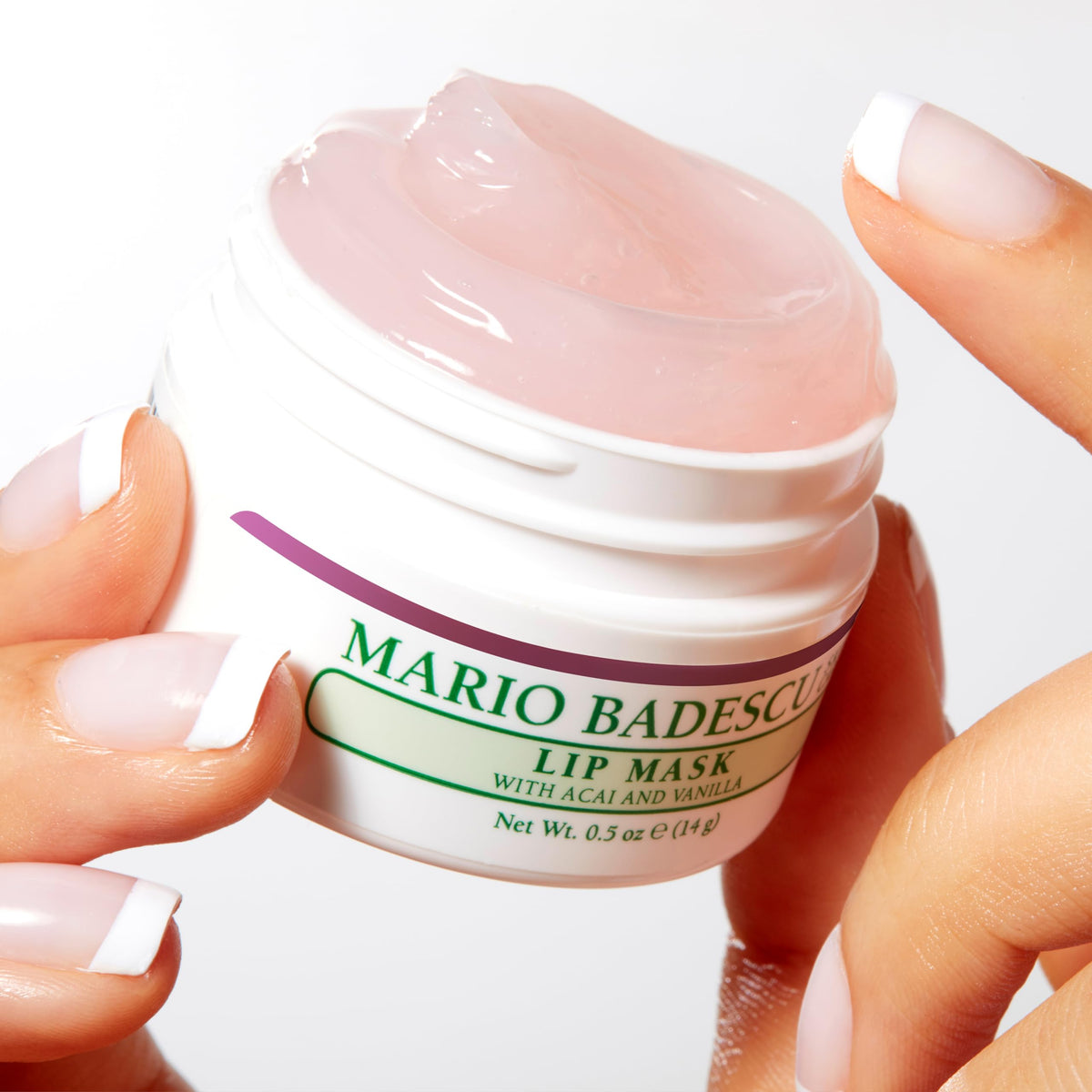 Mario Badescu jar held in hand showing scale of 0.5 ounce for travel-friendly convenience