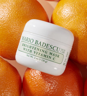 Mario Badescu jar held in hand to show 2 fl oz scale and travel-friendly size