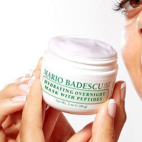 Mario Badescu next to a 2 fl oz cap for scale, showing compact travel-friendly size