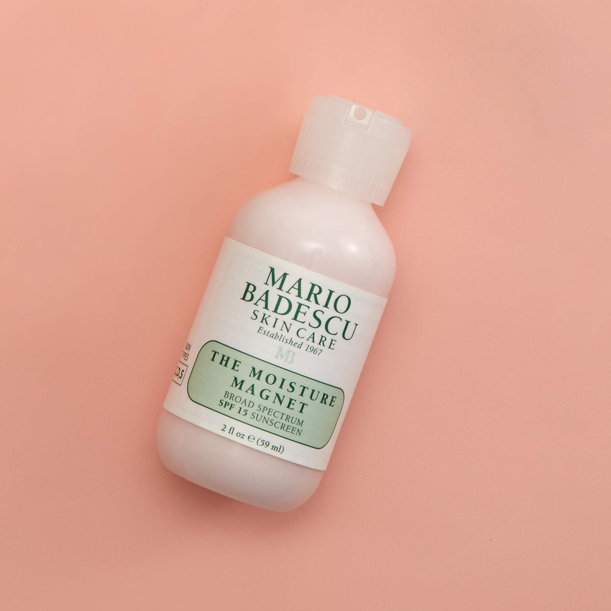 Mario Badescu applying product to hand to show lightweight absorption benefit