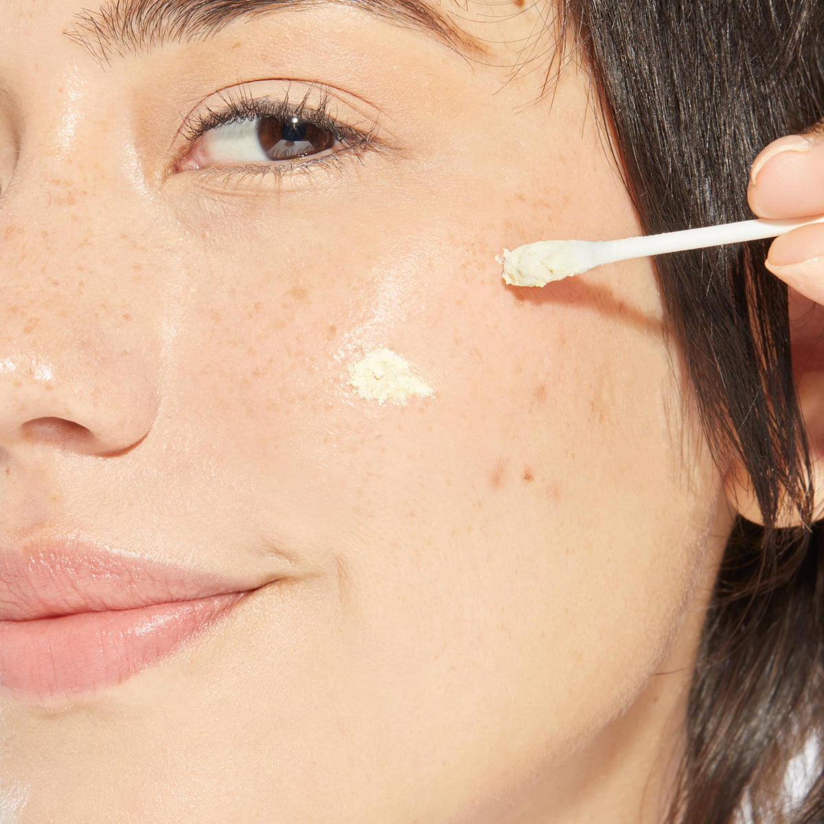 Mario Badescu powder on cotton swab ready for precise blemish application