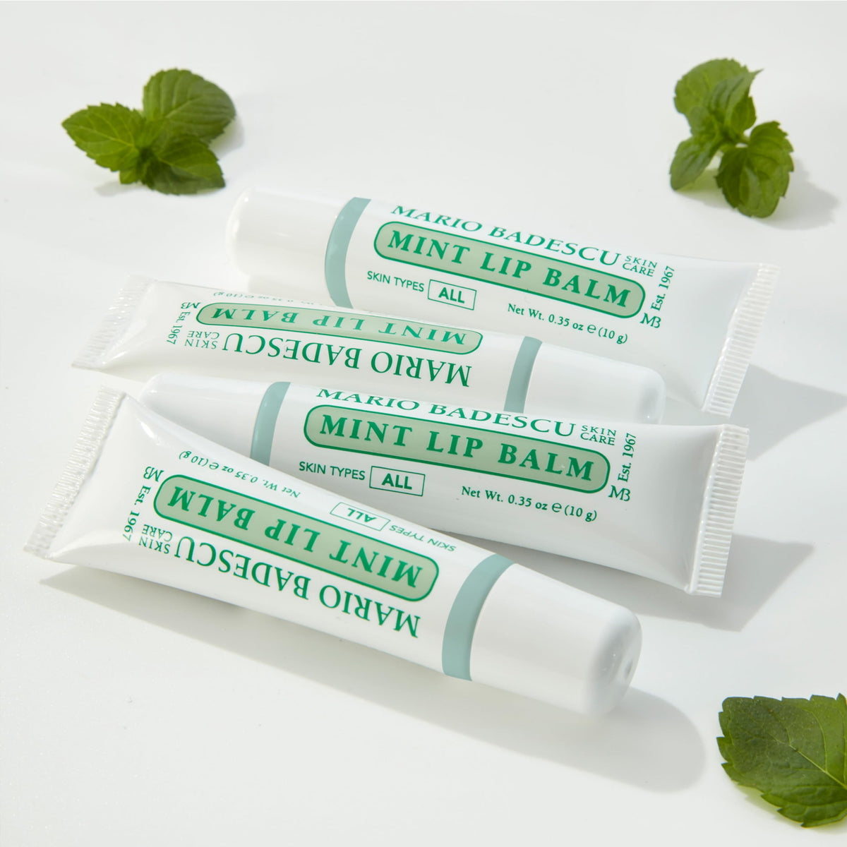 Mario Badescu Rose lip balm with cap off revealing soft tinted balm and gentle scent