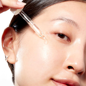 Mario Badescu applying serum to face demonstrating easy layering and hydration benefit