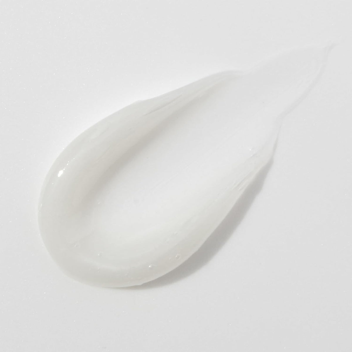 Mario Badescu tube next to coin showing compact size and portability