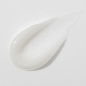 Mario Badescu tube next to coin showing compact size and portability