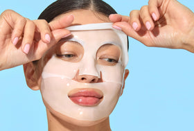 Mario Badescu mask placed beside coin to show compact size and travel ease