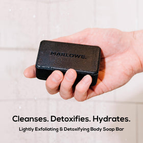 MARLOWE. charcoal bar close-up texture displays pumice detail for gentle exfoliation