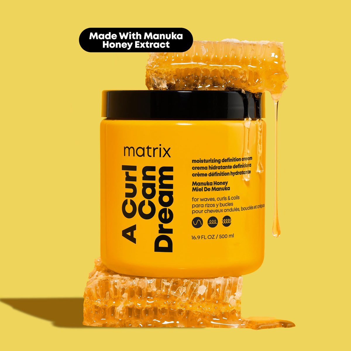 Matrix applying leave-in to wet curls for detangling and frizz control