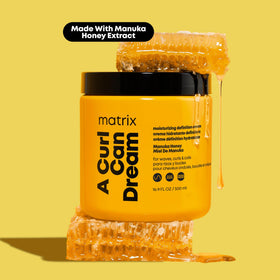 Matrix applying leave-in to wet curls for detangling and frizz control