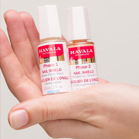 MAVALA brush applying phase one to a fingernail for reinforcement