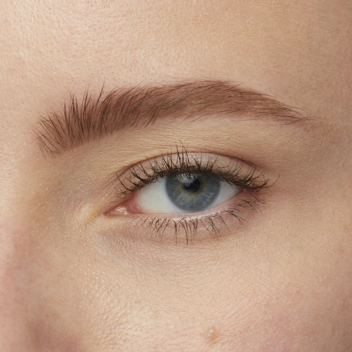 Maybelline Brow Tattoo size comparison in hand to show travel-friendly 4.9 ml