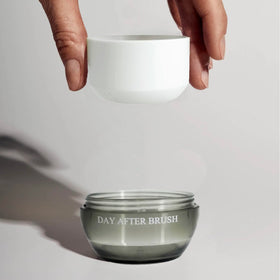 m'chel brush in use applying powder to roots for refreshed, voluminous hair