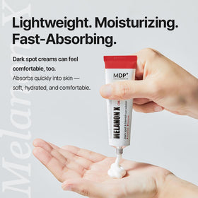 MDP Melanon X in hand scale showing product size and travel-friendly convenience
