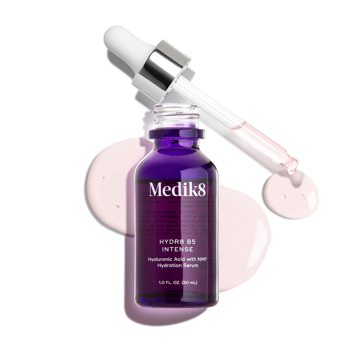 Medik8 1 oz bottle next to a coin for scale showing travel-friendly size