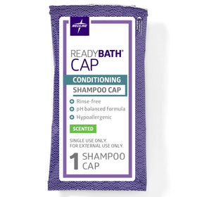 Medline ReadyBath cap next to a hand for scale demonstrating single-use convenience