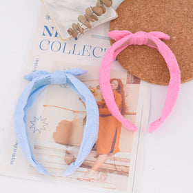 Melbelia headbands styled with outfit flatlay showing color-matching versatility