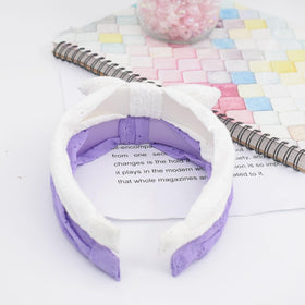 Melbelia headband beside coin showing size and adjustable fit benefit