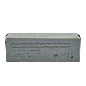 MERIT bronze balm being blended with finger showing easy application benefit