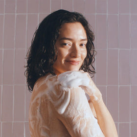 Method styled in bathroom setting with flowers, suggests uplifting floral scent benefit