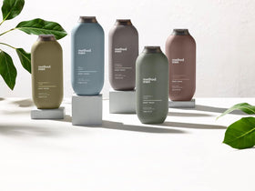 Method bottle on bathroom shelf in lifestyle scene suggesting refined scent