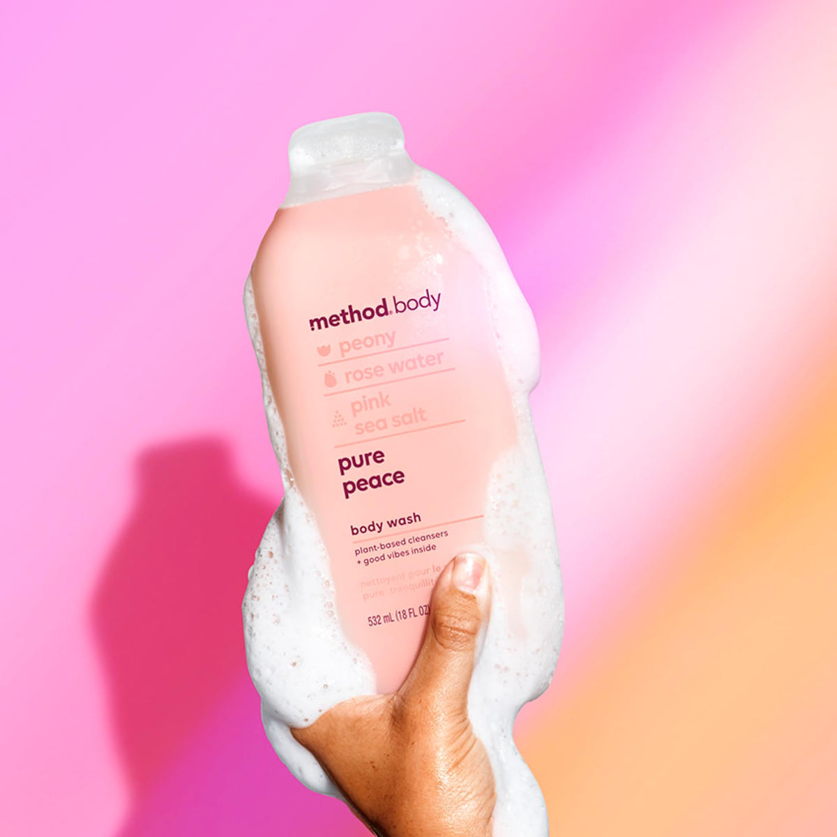 Method bottle next to hand to show 18 oz scale and long-lasting benefit