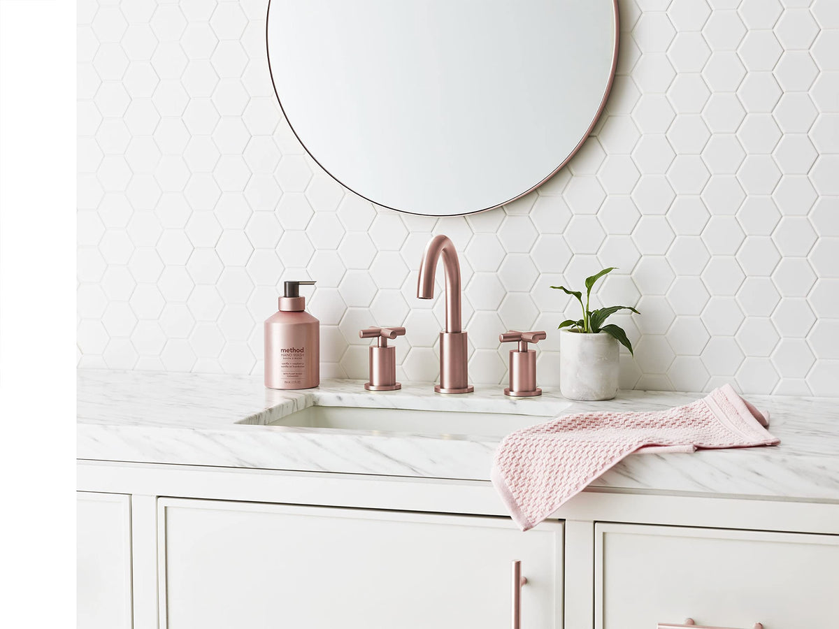 Method bottle next to hand and sink for scale and practical size reference