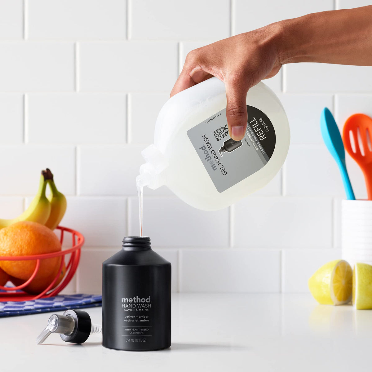 Method vetiver + amber bottle held beside hand showing 12 oz scale and single-use reduction
