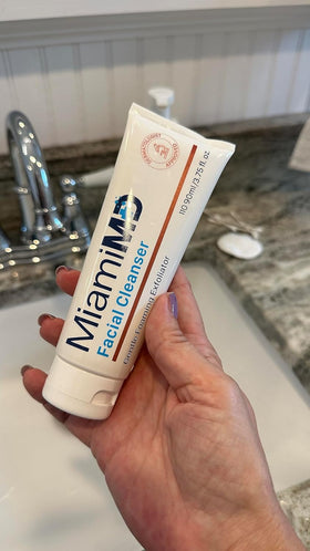 MiamiMD bottle beside a hand for size comparison and travel-friendly benefit
