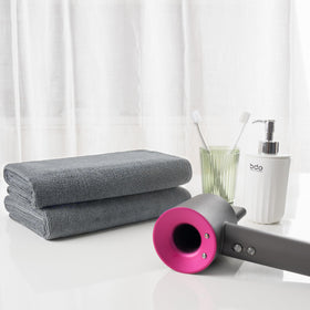 MICROFI folded towel next to hand showing generous size and easy handling