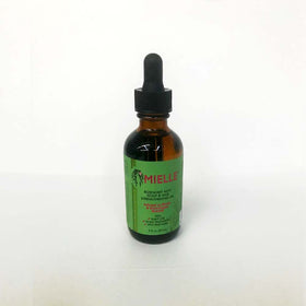 Mielle Organics strengthening oil drops on fingertip showing nourishment and split-end protection benefit