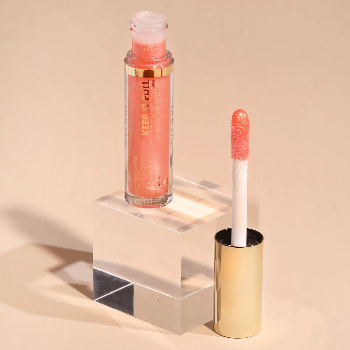 Milani gloss on vanity being applied for on-the-go refresh and polished look benefit