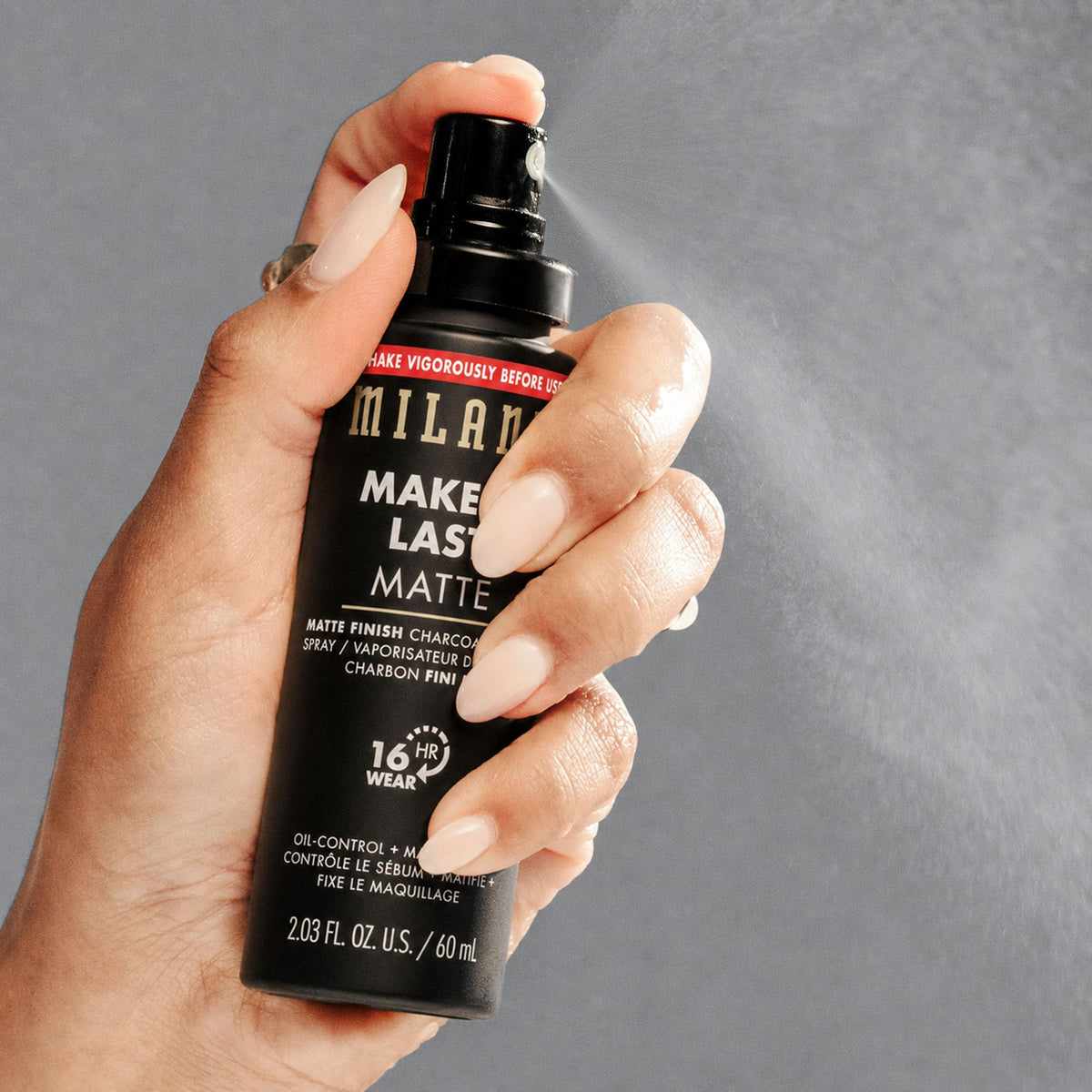 Milani spray near face demonstrating quick application and non-disturbing finish