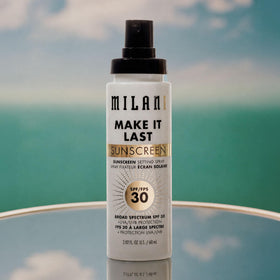 Milani mist on bare skin illustrating quick sunscreen refresh without makeup disruption