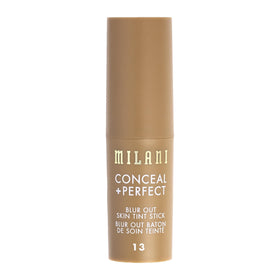 Milani stick beside brush and sponge showing compact size and use