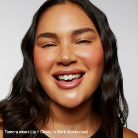 Milk Makeup applying Werk on cheeks in lifestyle shot showing natural flushed finish benefit