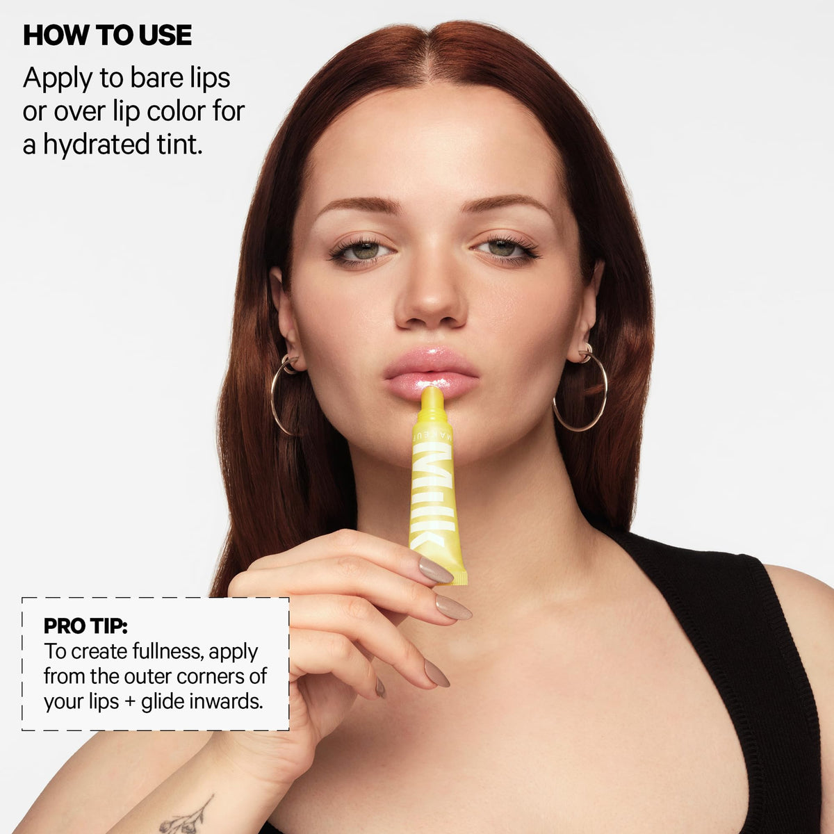 Milk Makeup balmade applied on lips showing sheer tint and plumping effect
