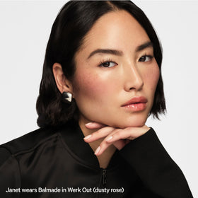 Milk Makeup balmade applied on model lips demonstrating sheer color and plumping look