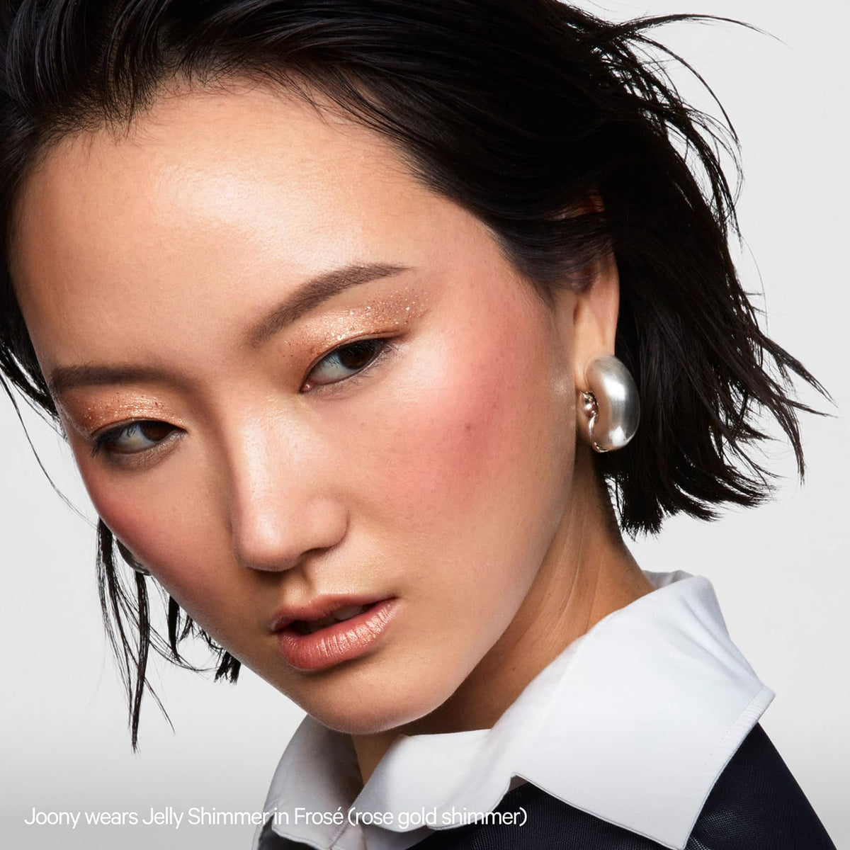 Milk Makeup Frosé on collarbone demonstrates multiuse highlight and long-lasting sheen