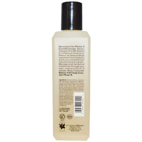Mill Creek bottles next to a hand for Biotene H-24 size comparison and travel-friendly benefit